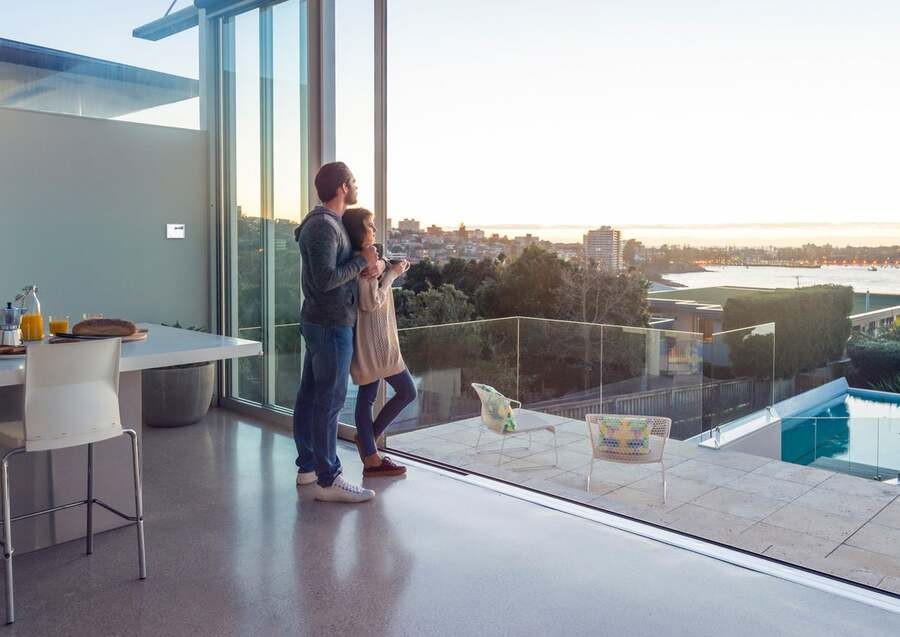  A couple stands on their terrace watching the skyline.